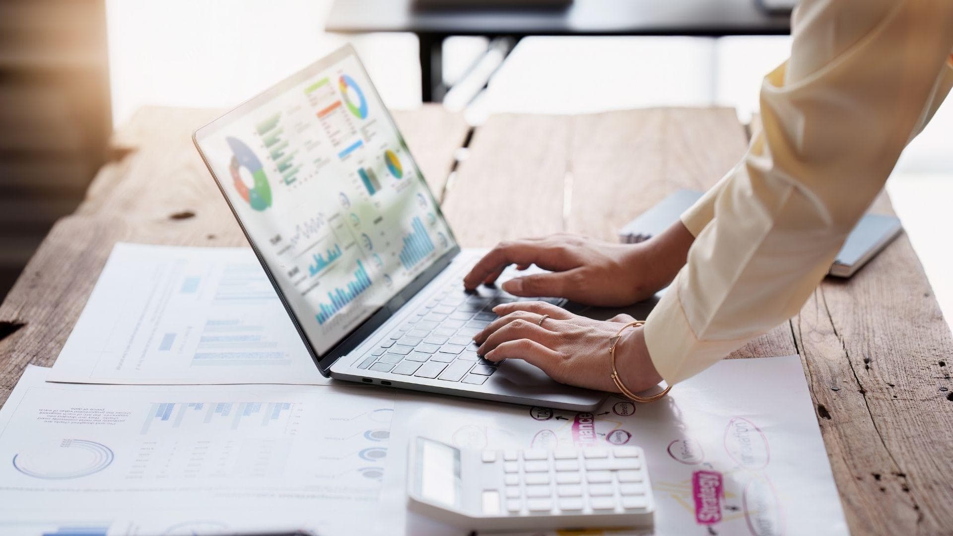 A consultant working through analytics on a laptop.