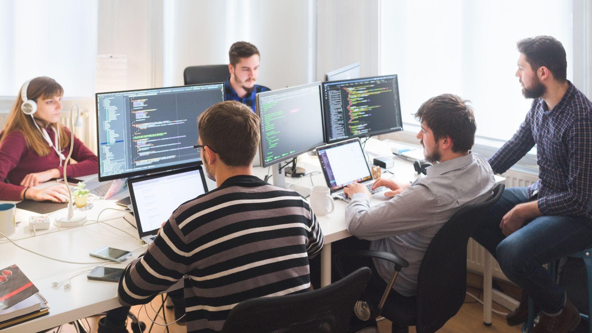 A software engineer building and reviewing code on screen.